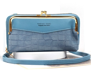 Detail of blue faux leather crossbody phone bag with stone texture and gold clasp