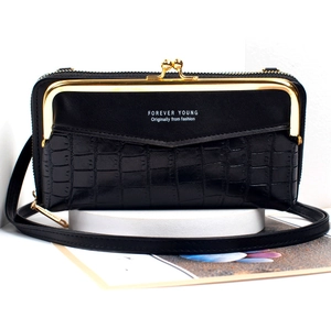 Detail of black faux leather phone bag featuring stone texture and gold metal clasp