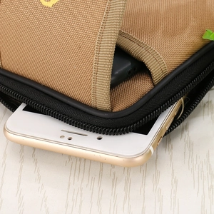 Detail view of khaki canvas waist bag with multi-layer pockets for smartphones