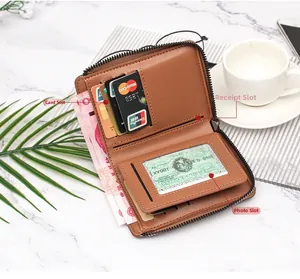 Detail view of brown leather wallet interior showing card slots and ID window on marble