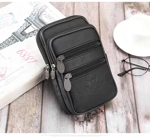 Vue détaillée du sac ceinture en cuir grainé noir avec trois poches zippées et logo