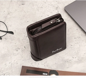 Detail view of deep brown tri-fold leather wallet with zipper closure and card slots