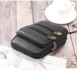 Détail d'une pochette de ceinture en cuir noir avec trois compartiments à glissière