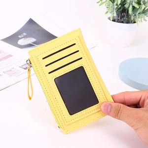 Slim yellow card holder with zipper pocket and cat-ear design in lychee pattern leather