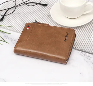 Detailed view of a brown men's wallet with signature tri-color stripe on marble table