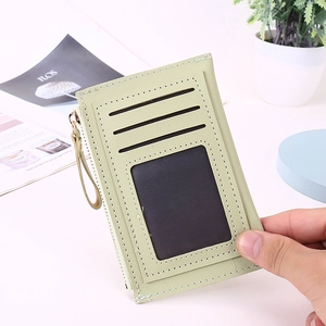Detail of mint green slim card holder featuring three card slots and a metal zipper pouch