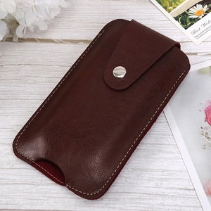 Deep brown leather phone holster with snap button and white stitching on wood surface
