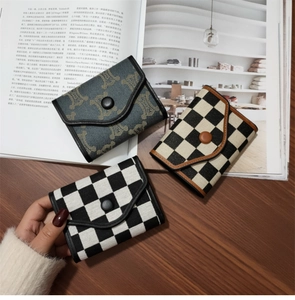 Detailed view of vintage folding wallets with plaid and classic pattern designs