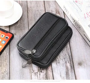 Détail d'une pochette de ceinture noire en cuir grainé avec compartiments à fermeture éclair