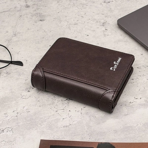 Deep brown tri-fold men's wallet with zipper detail on a professional office desk