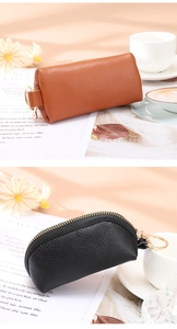 Detail of synthetic leather coin purses with litchi texture and golden zip hardware