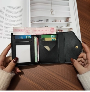 Interior detail of a trifold leather wallet showing card slots and ID window