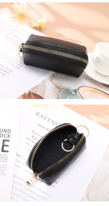 Detail of black lychee leather coin purse with gold zipper and internal key ring