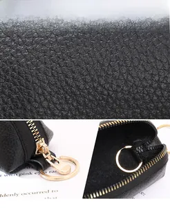Detail of black lychee grain leather coin purse with gold zipper and key ring
