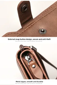 Macro view of brown leather wallet featuring contrast stitching and silver metal zipper