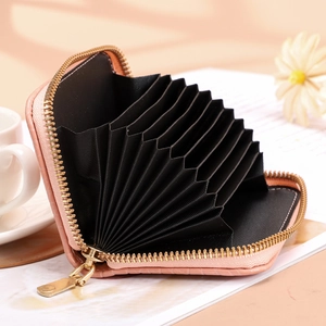Pale pink crocodile pattern card holder with multiple accordion slots and gold zipper