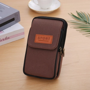 Detail view of brown canvas belt pouch with dual zippers and Sport label on wooden desk