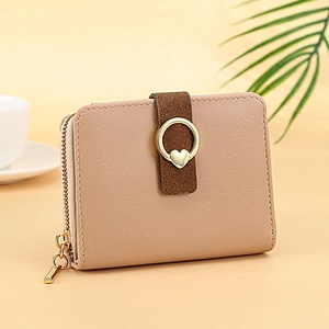 Petit portefeuille femme en cuir rose avec détail cœur et fermeture éclair dorée