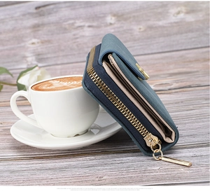 Detail view of the Morandi green wallet with multiple layers and golden zipper