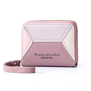 Detail of color-block PU leather wallet with pink and purple panels and wrist strap