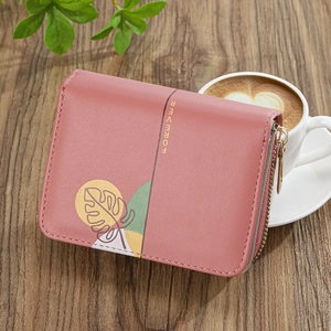 Pink PU leather short wallet with gold zipper and leaf print on wood surface