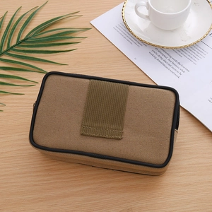 Macro detail of brown canvas tactical waist bag with velcro patch on wooden desk