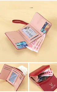Detail of red PU leather tri-fold wallet with card slots, zipper pocket and deer logo