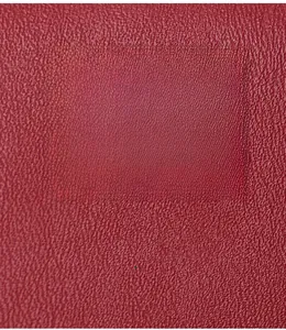 Close-up of red PU leather with fine lychee texture showing durable and soft material