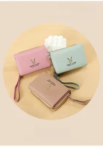 Detailed view of trifold PU leather mini wallets featuring gold deer metal decoration