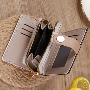 Detail of light khaki short wallet interior with card slots and golden zipper coin pocket