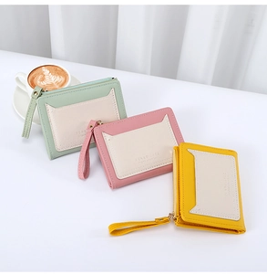 Detailed view of leather zipper coin purses in mint, pink and yellow with strap