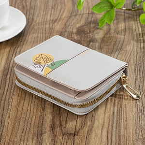 Detail of grey PU leather wallet featuring tropical leaf print and gold zipper puller