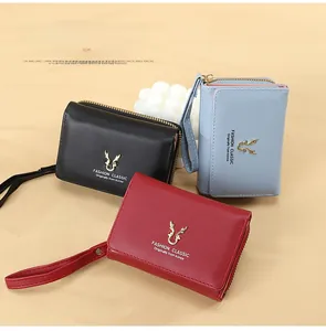 Three compact PU leather wallets with deer antler metal detail in black, blue, and red