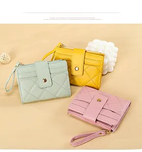 Quilted faux leather coin purses in mint green, yellow, and pink with wrist straps