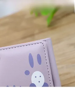Détail macro du portefeuille en cuir PU violet avec texture litchi et coutures soignées