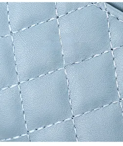 Detailed macro view of light blue quilted leather texture with precise diamond stitching