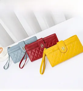 Three quilted faux leather wallets in blue, red, and yellow with metal ring closures