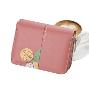 Women's pink multi-slot short wallet featuring gold lettering and leaf pattern on white