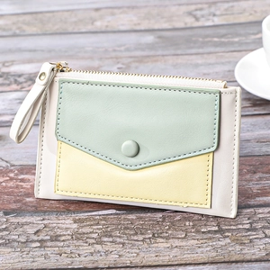 Detailed view of tri-color slim leather wallet featuring mint green and beige stitching