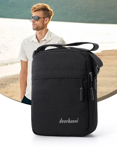 Detailed close-up of a black lightweight crossbody bag with front zipper and brand logo