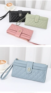 Close-up of quilted long wallets with wrist straps and metal buckles in four soft colors