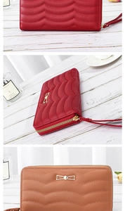Macro view of long quilted leather wallet with gold bow detail and wrist strap