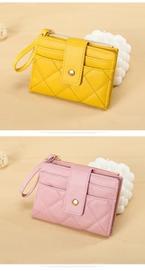 Detail of quilted leather mini wallets in yellow and pink with card slots and wrist straps