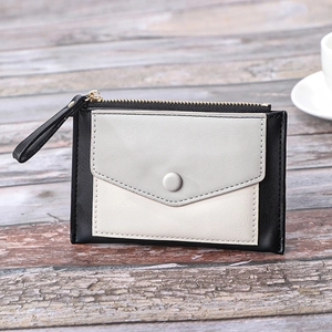 Close-up of color-block slim leather wallet showing zipper pocket and snap card slot