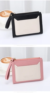 Short zipper wallet in black and pink with multi-card slots and a wrist strap