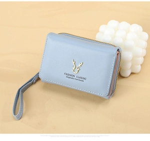 Detail of light blue PU leather wallet featuring golden deer logo and hand strap