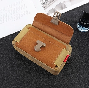 Detail view of khaki tactical oxford phone pouch with side slots and buckle closure