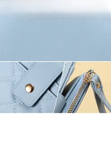 Detail of light blue quilted leather wallet with gold hardware and wrist strap