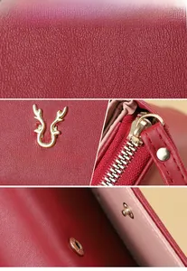 Close-up of red litchi grain PU leather wallet with golden stag logo and zipper detail