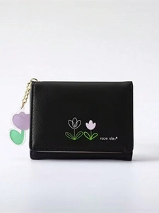 Detail of black tri-fold PU wallet featuring a tulip print and acrylic flower charm